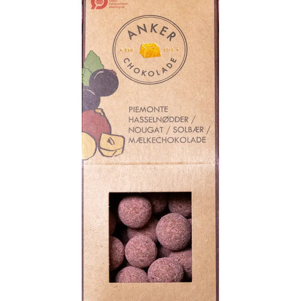 Anker Chokolade dragée 105 g med Piemonte hasselnødder, mælkechokolade og solbærpulver – økologiske chokoladedragéer med sprød nøddekerne, frugtig solbærnote og cremet chokolade
