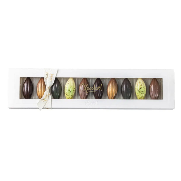 Xocolatl Cocoapods 90 g – fyldte chokolader med passionsfrugtpuré og citronpuré i chokolade med fløde, sødmælks-/helmjölkpulver og hasselnødder, opbevares ved 15–18 grader